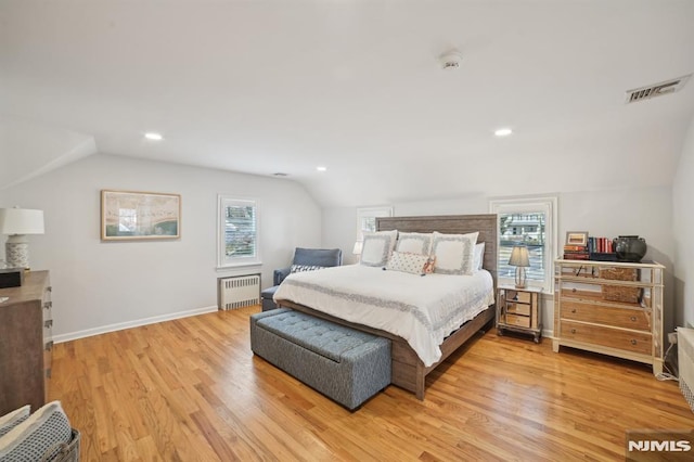 bedroom featuring visible vents, multiple windows, radiator, and light wood-style flooring