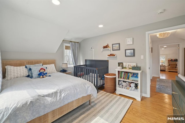 bedroom featuring vaulted ceiling, recessed lighting, wood finished floors, and baseboards