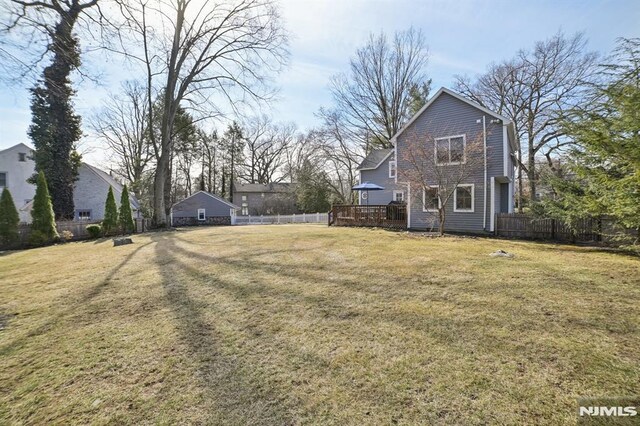 view of yard featuring fence and a wooden deck