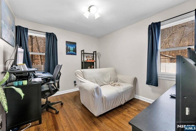 office area with baseboards and wood finished floors