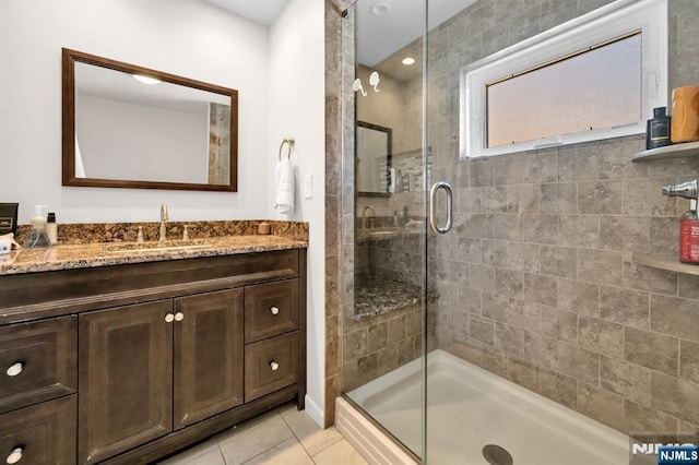 full bath featuring tile patterned floors, a shower stall, and vanity