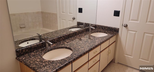 full bath featuring double vanity and a sink