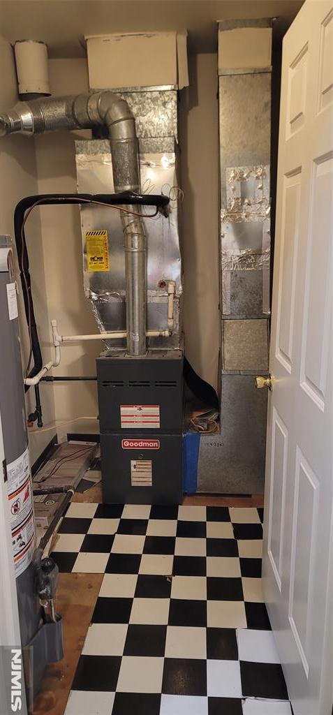 utility room featuring water heater