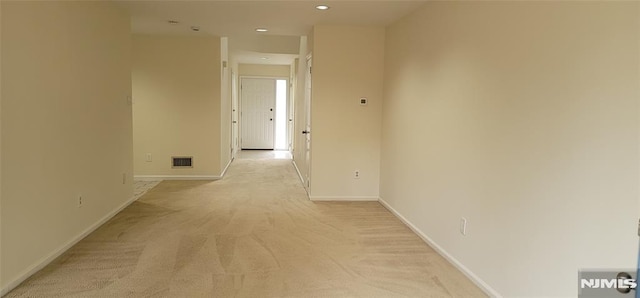 hall with light carpet, visible vents, recessed lighting, and baseboards