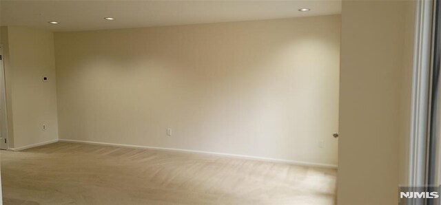 unfurnished room featuring recessed lighting, baseboards, and light colored carpet