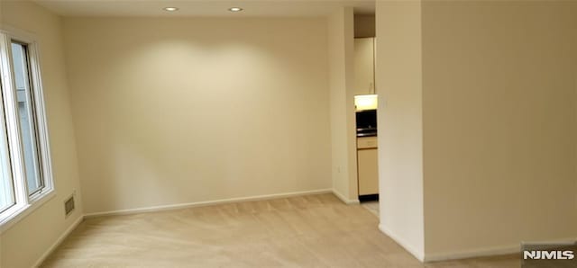 unfurnished room with recessed lighting, baseboards, light carpet, and visible vents