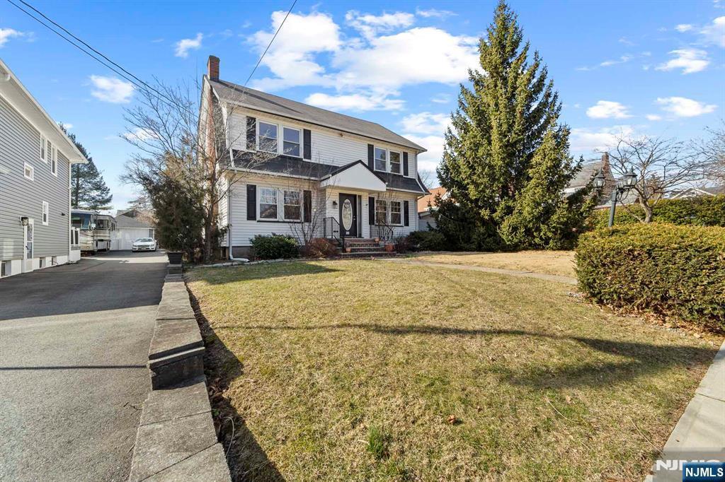 view of front of property featuring a front lawn and a chimney