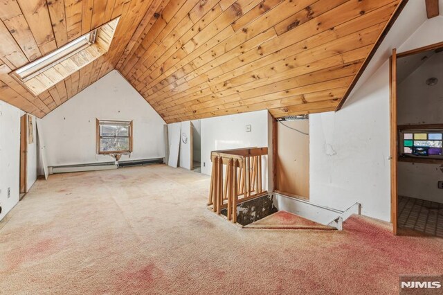 additional living space featuring wooden ceiling, vaulted ceiling with skylight, baseboard heating, and carpet floors