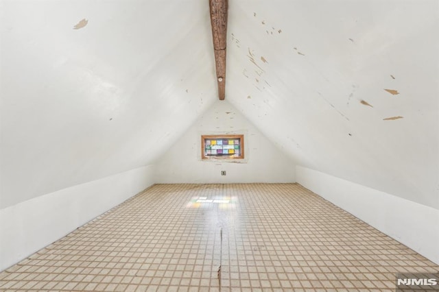 bonus room featuring vaulted ceiling with beams