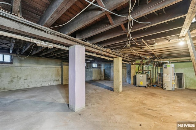 below grade area featuring gas water heater and a heating unit