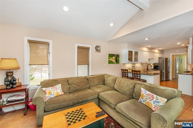 living room featuring recessed lighting, visible vents, light tile patterned flooring, and vaulted ceiling with beams