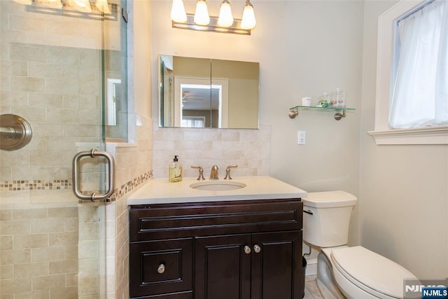 full bath featuring backsplash, a stall shower, toilet, and vanity