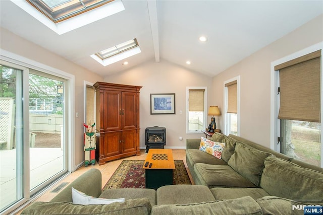 living area with baseboards, lofted ceiling with skylight, light tile patterned floors, recessed lighting, and a wood stove