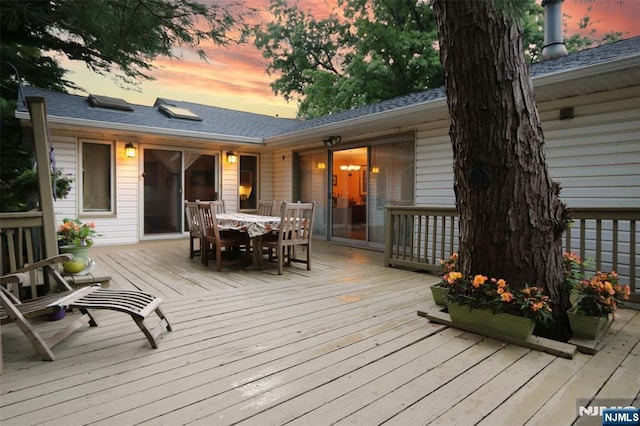 wooden terrace featuring outdoor dining area