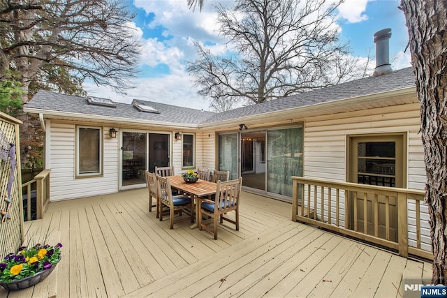 wooden terrace with outdoor dining area