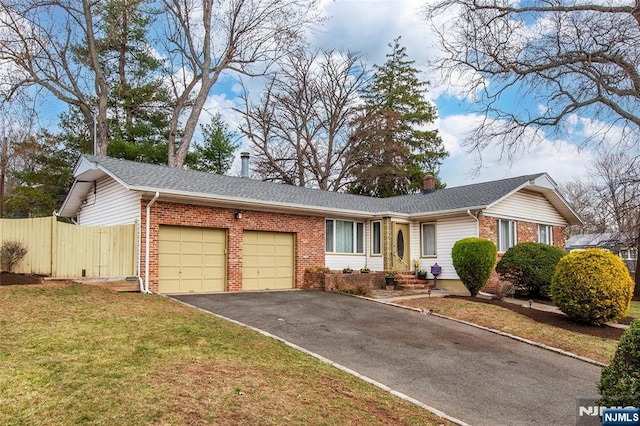 single story home with an attached garage, fence, brick siding, and driveway