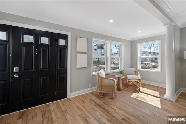 entrance foyer featuring baseboards, ornate columns, recessed lighting, light wood-style floors, and crown molding