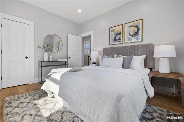 bedroom featuring recessed lighting, baseboards, and wood finished floors