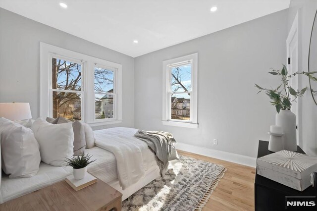 bedroom with recessed lighting, baseboards, and light wood-style flooring