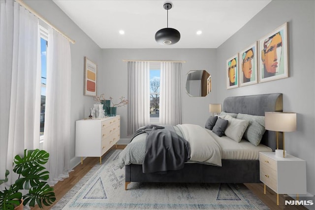 bedroom with recessed lighting and wood finished floors