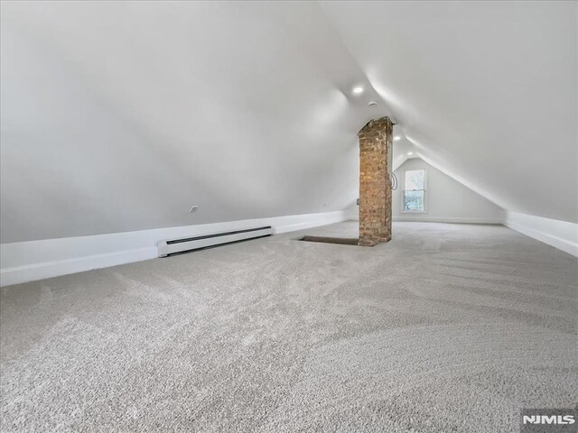 additional living space with baseboards, carpet, lofted ceiling, and a baseboard radiator