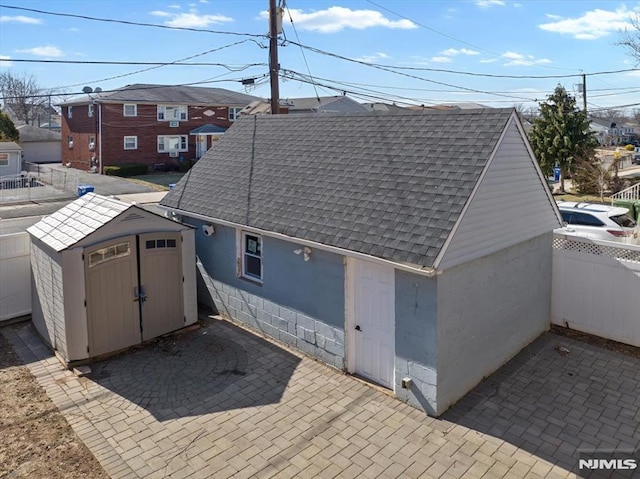 view of shed featuring fence