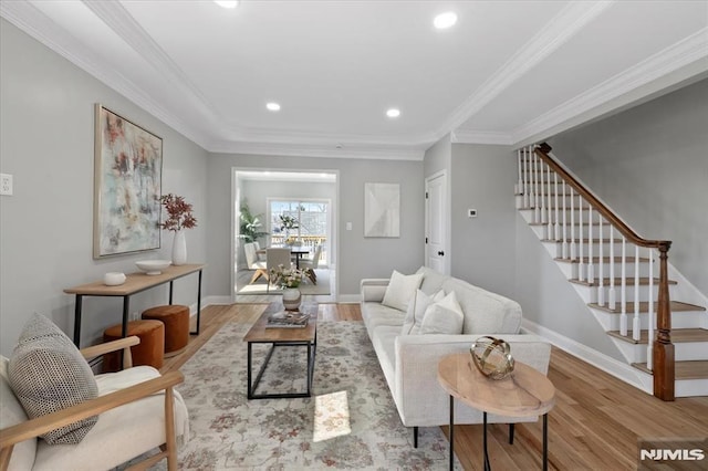 living area with baseboards, stairs, ornamental molding, recessed lighting, and wood finished floors