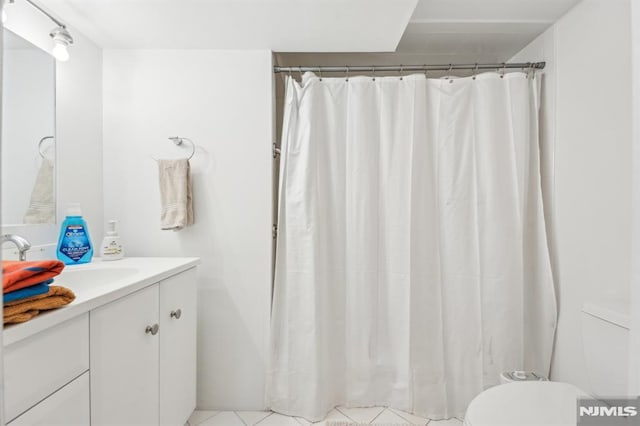 bathroom with vanity, toilet, and a shower with curtain