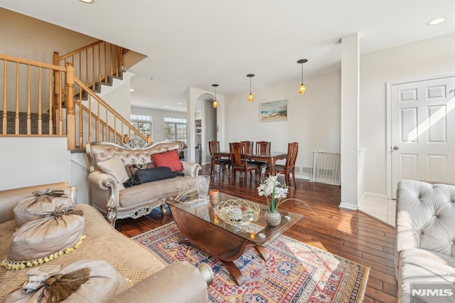 living area with stairway, recessed lighting, baseboards, and hardwood / wood-style floors