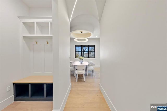 mudroom featuring light wood-style flooring and baseboards