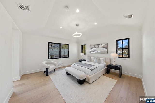 bedroom with light wood-style flooring, multiple windows, and visible vents