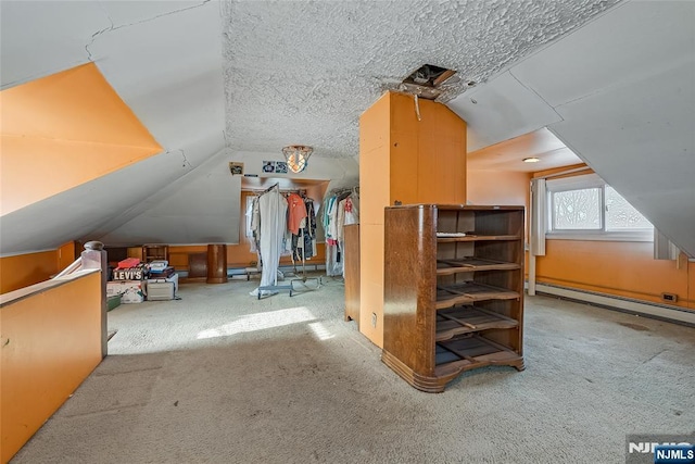 bonus room featuring a textured ceiling, baseboard heating, carpet flooring, and vaulted ceiling