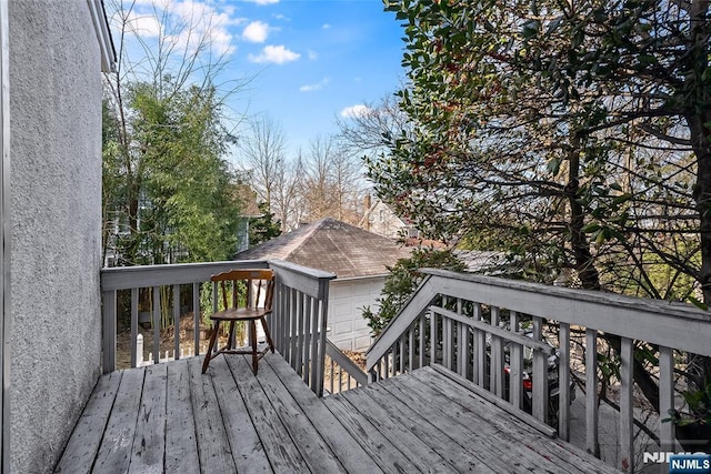 wooden terrace featuring a garage