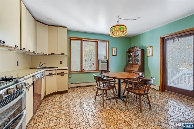 dining room with a baseboard heating unit, a healthy amount of sunlight, and baseboards