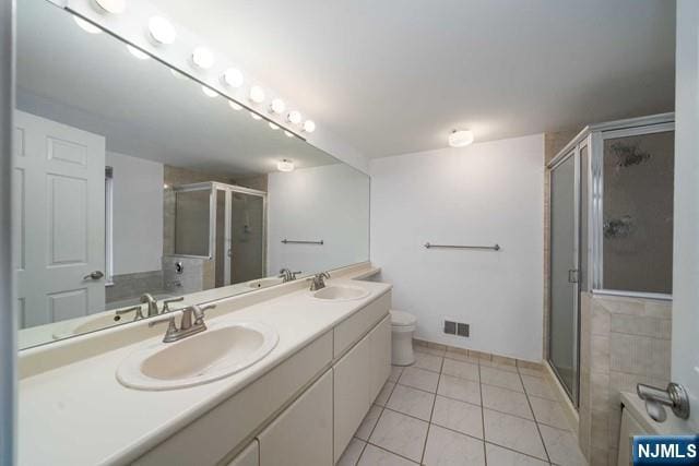 full bath featuring a sink, visible vents, a stall shower, and tile patterned flooring