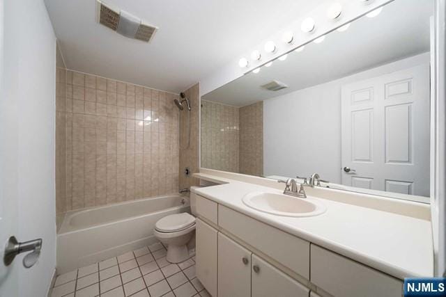 bathroom featuring visible vents, toilet, shower / bathing tub combination, tile patterned floors, and vanity