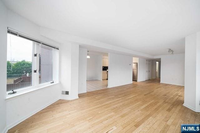 spare room with visible vents and light wood-style floors