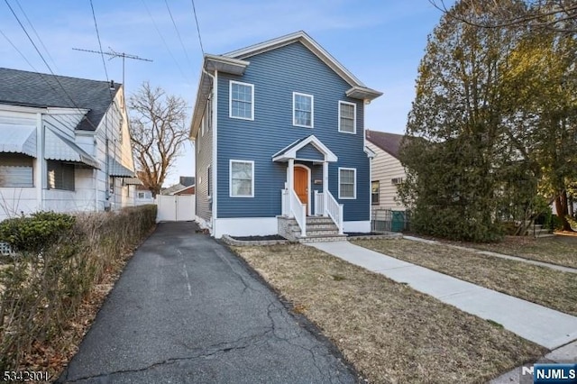 view of front of property featuring fence