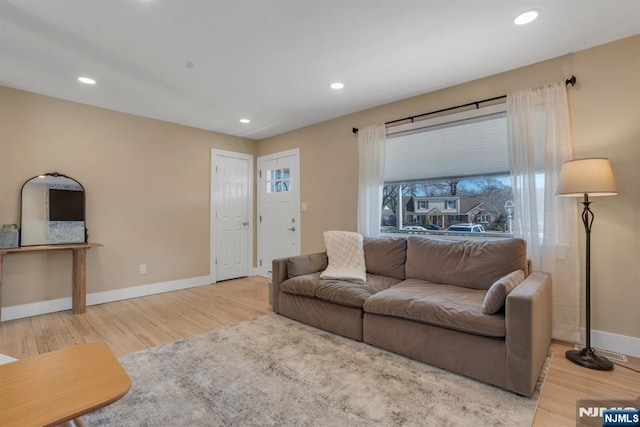 living room with recessed lighting, baseboards, and wood finished floors