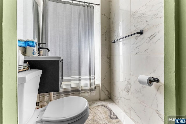 bathroom with marble finish floor and toilet