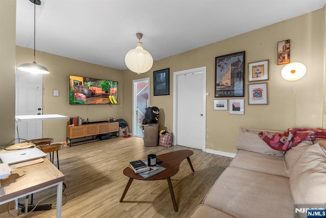 living area with wood finished floors and baseboards