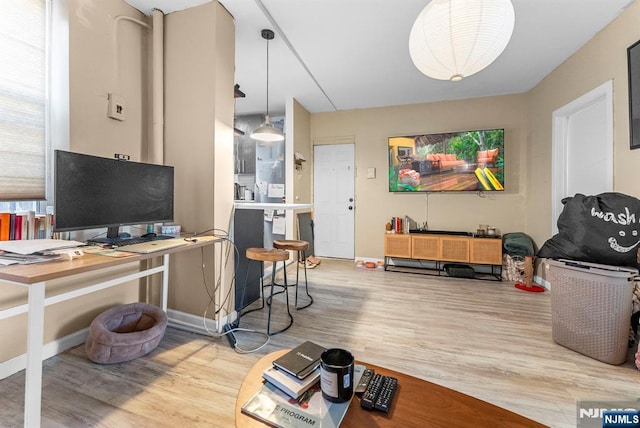 office area with baseboards and wood finished floors