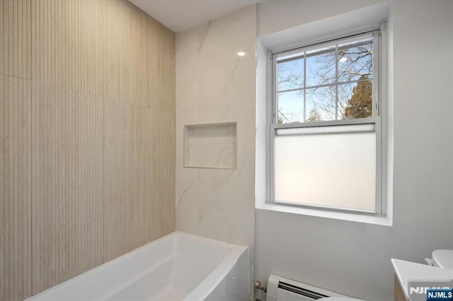 full bathroom featuring toilet, vanity, a baseboard heating unit, and bathtub / shower combination