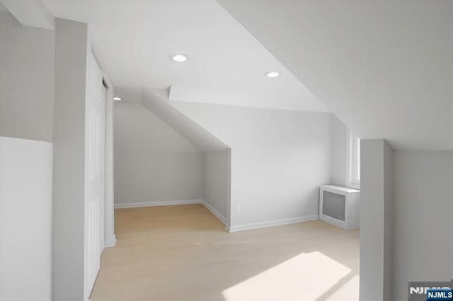 additional living space featuring recessed lighting, baseboards, lofted ceiling, and wood finished floors