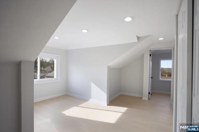 bonus room featuring vaulted ceiling, recessed lighting, baseboards, and light wood-type flooring