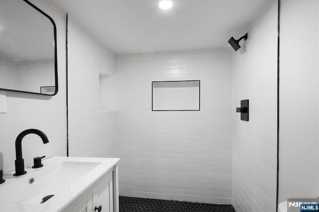 full bathroom featuring a stall shower and vanity