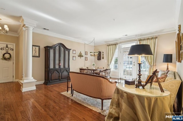 sitting room featuring decorative columns, visible vents, wood finished floors, and crown molding