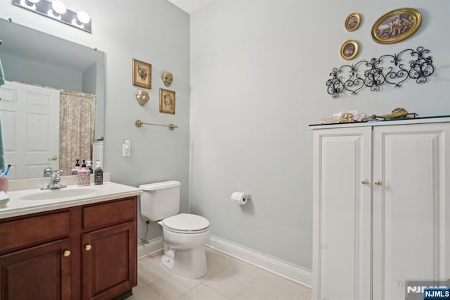 full bathroom with vanity, toilet, baseboards, and tile patterned flooring