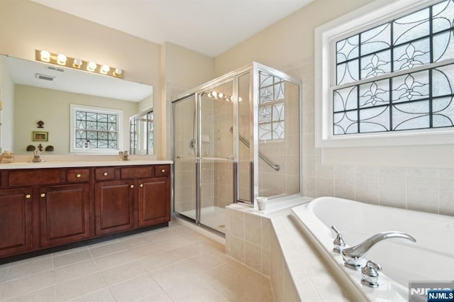 full bath with tile patterned flooring, visible vents, a garden tub, double vanity, and a stall shower