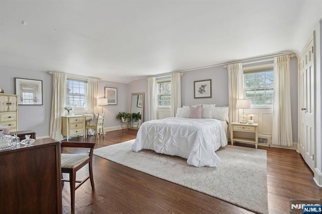 bedroom featuring dark wood-style floors and baseboards